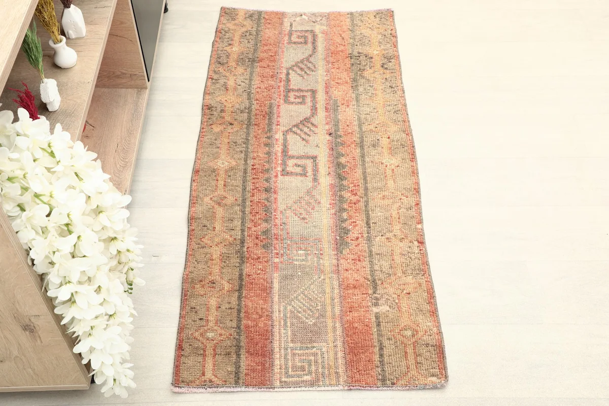 Overhead view of the vintage Anatolian rug, highlighting its full length and geometric patterns.