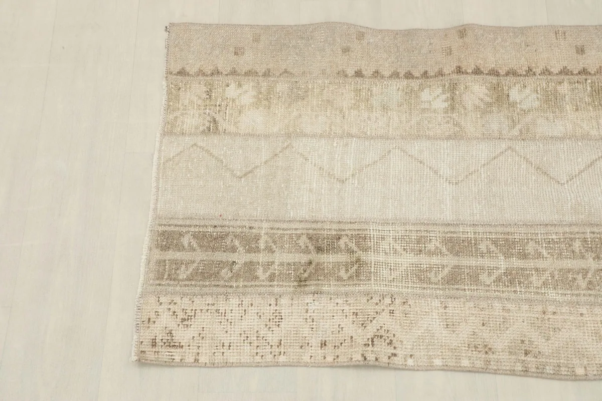 Detail shot of the rug's left side, showcasing subtle patterns and faded areas.