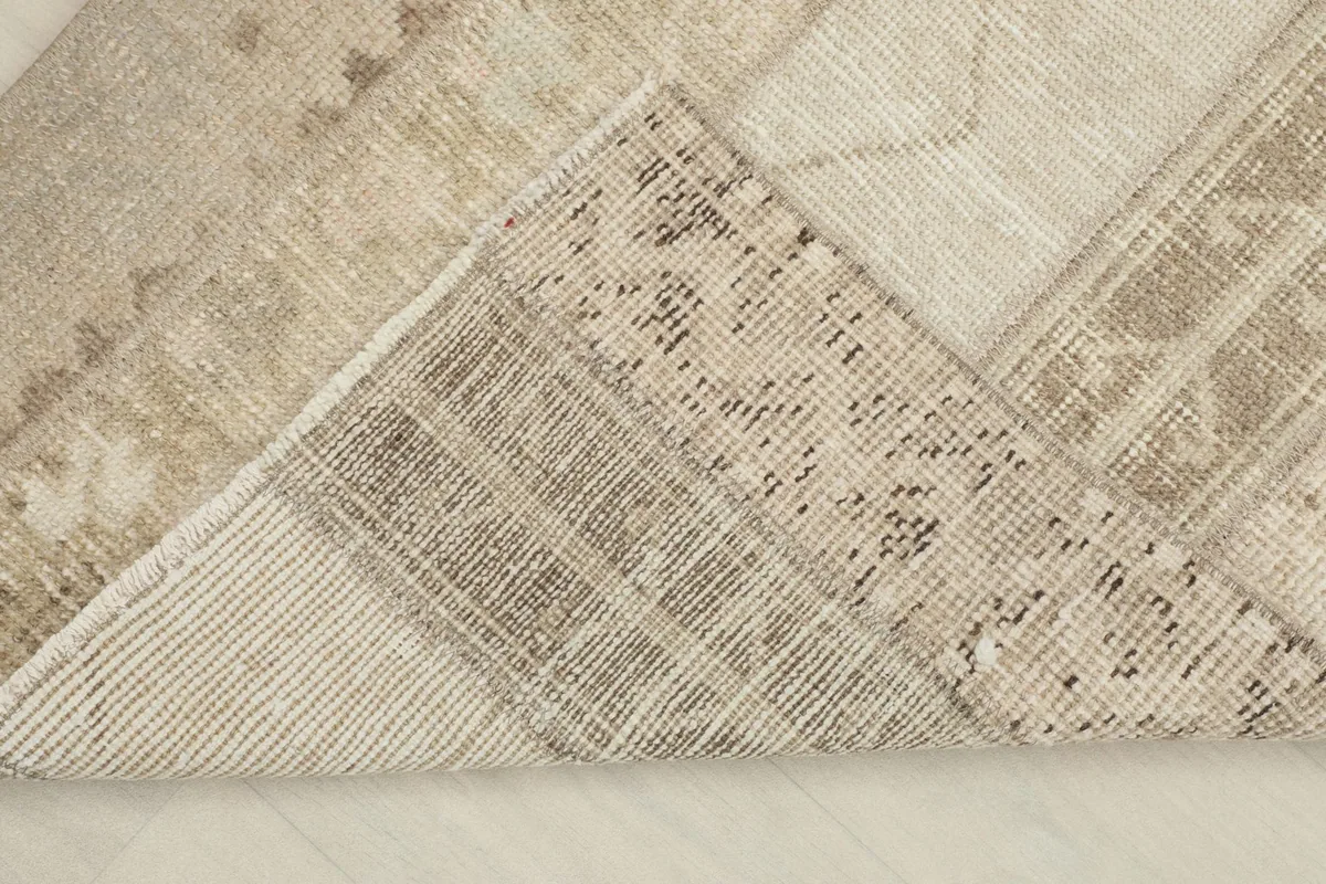 View of the rug's underside, revealing the hand-knotted construction on a cotton foundation.