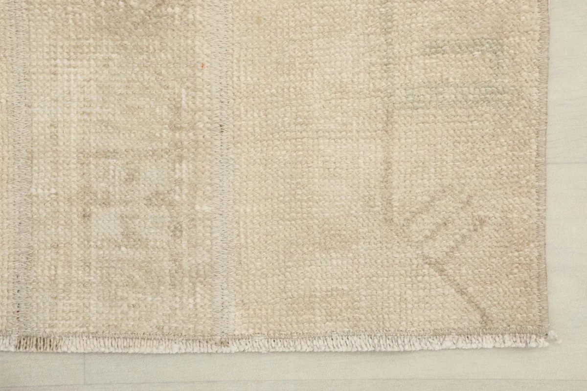 Detail shot of the rug's edge and fringe, showcasing the hand-knotted craftsmanship.