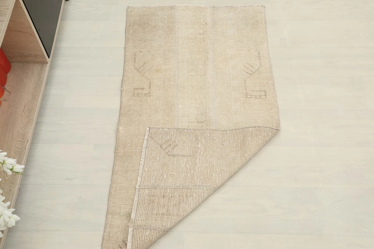 The rug partially folded, illustrating its flexibility and construction.