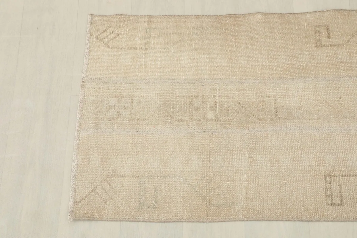 Overhead view focusing on the lower half of the rug, displaying the subtle tribal motifs.