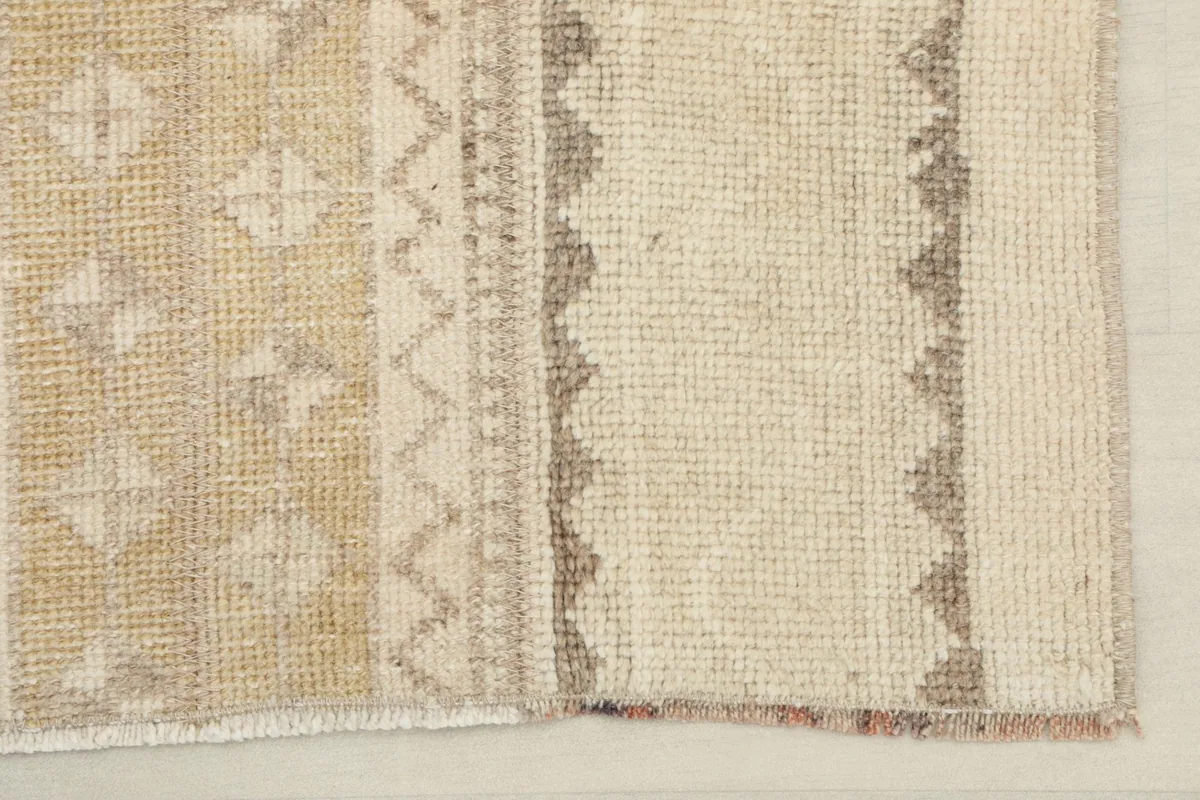 Close-up showing the varied colors and textures of the low pile rug