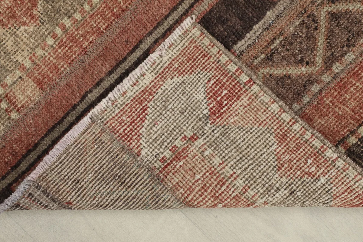 View of the rug's underside, revealing the cotton foundation and hand-knotted construction.