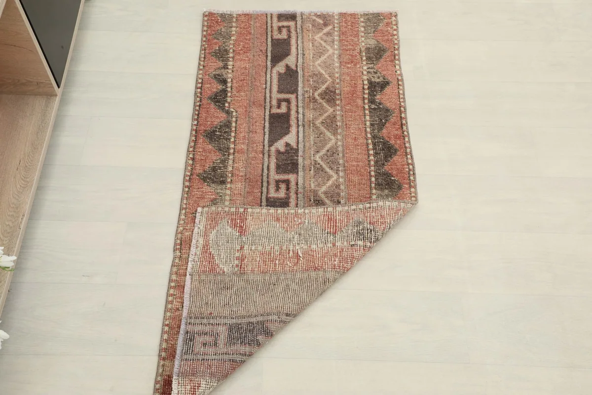 The rug folded to show its flexibility and thickness, with a partial view of the design.