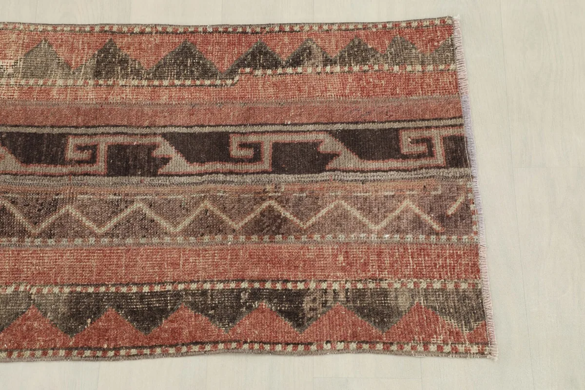 Overhead view showing the top section of the rug's tribal geometric design and colors.