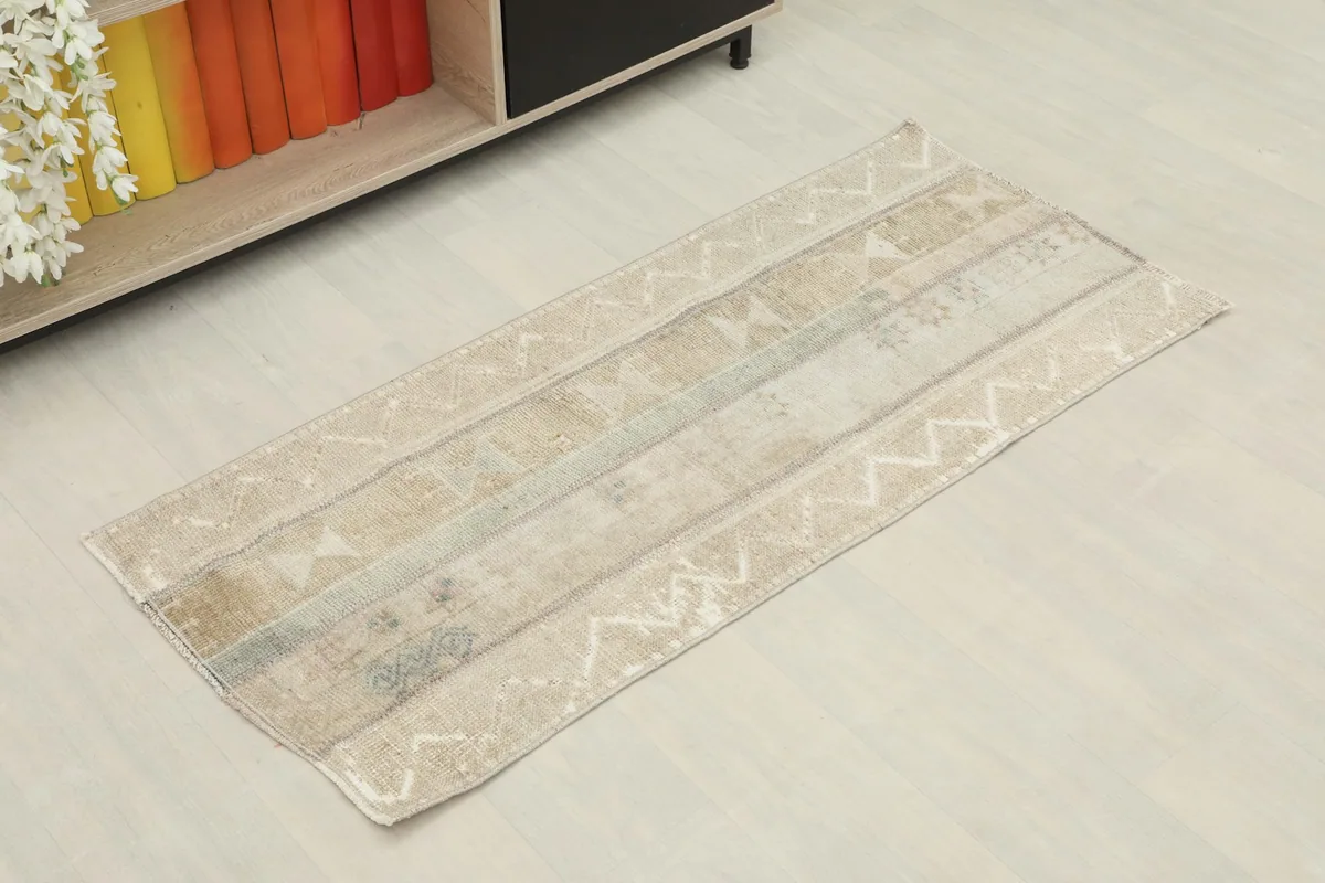 Angled view of the tan and blue striped area rug in a room setting