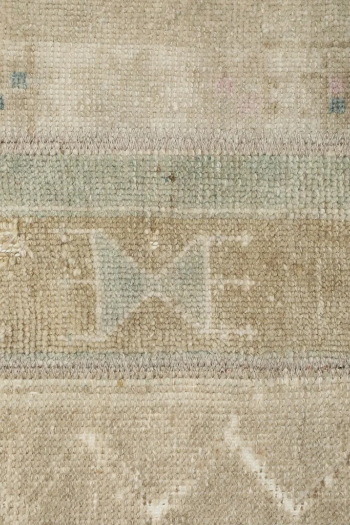 Macro detail of the hand-knotted wool pile and subtle color variations