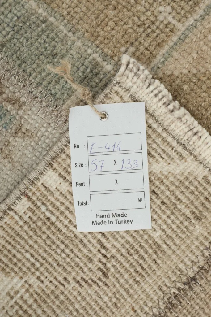 Back of the rug with a size tag, showing the hand-knotted cotton foundation