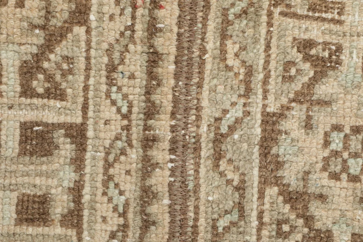 Extreme close-up of the low wool pile, revealing the hand-knotted construction and individual fibers.