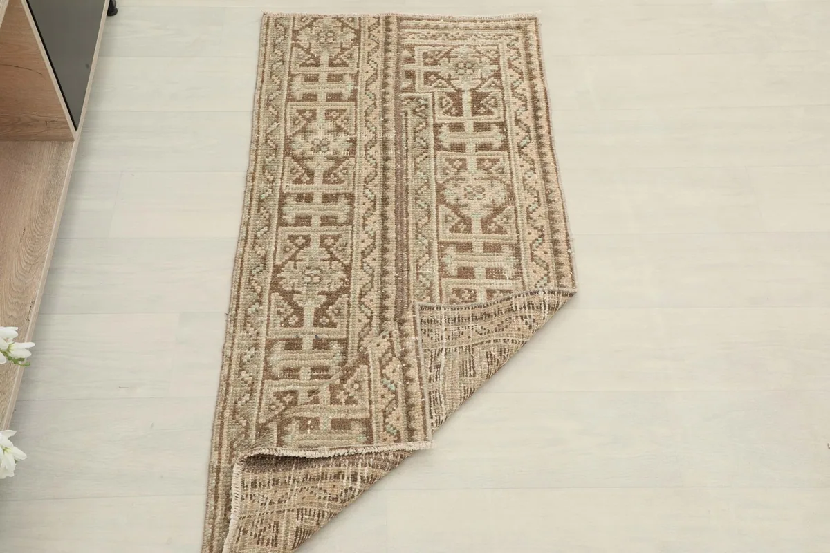The rug partially folded, showing its flexibility and the overall design from an elevated perspective.