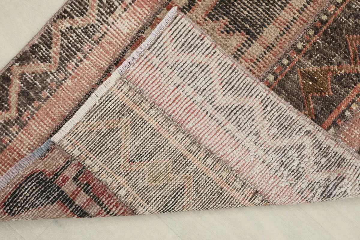 View of the back of the hand-knotted rug, showing the cotton foundation and knot structure