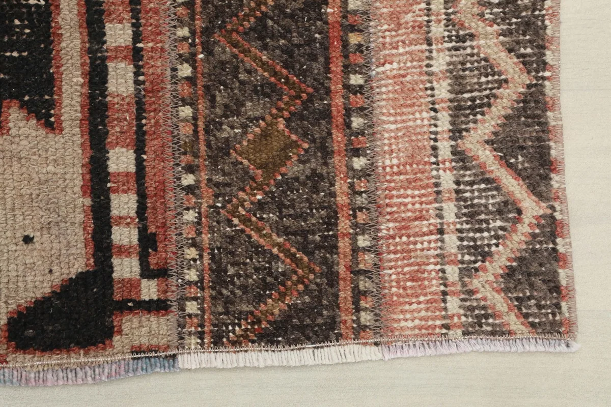 Detail showing the short, natural fringe and the edge of the rug, with visible knots