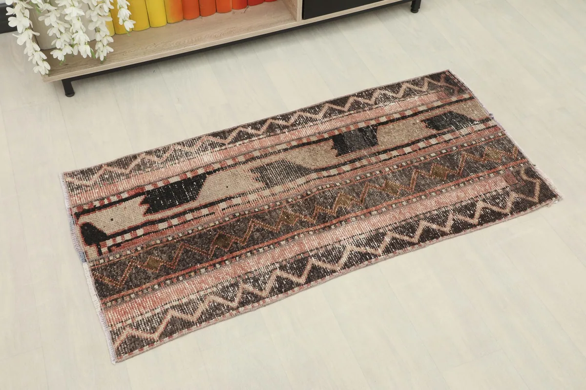 Overhead view of the vintage Anatolian rug, highlighting its striped geometric patterns and colors