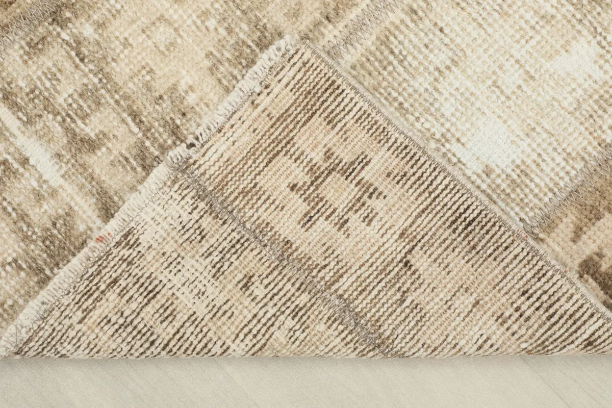 View of the back of the rug, showing the cotton foundation and hand-knotted construction.