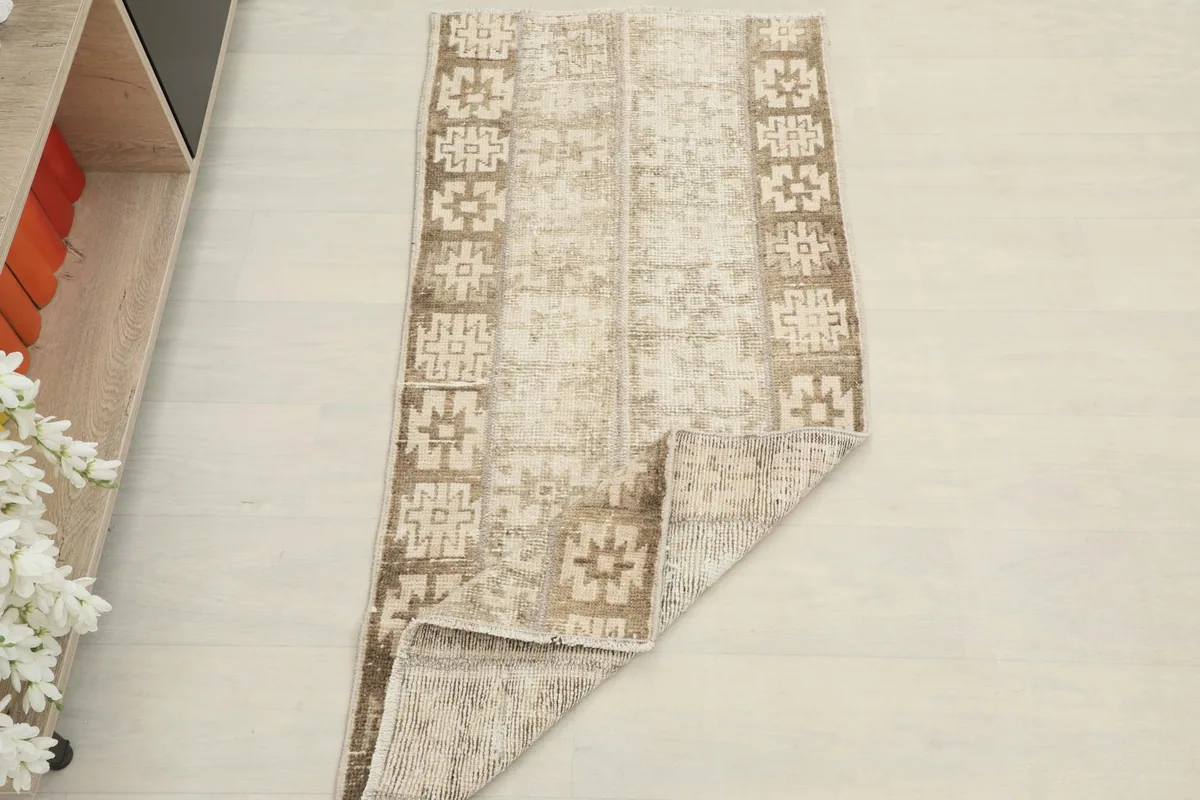 The rug partially folded, demonstrating its flexibility and showing the full pattern.