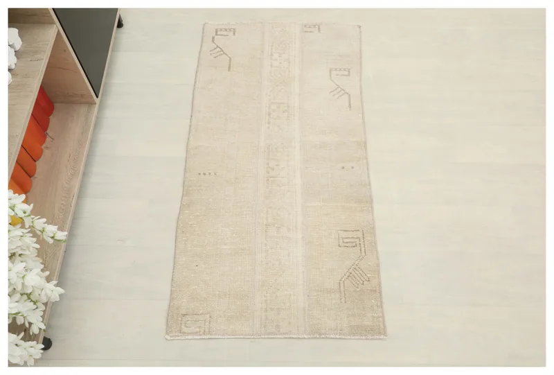 Full overhead view of the beige vintage Anatolian rug with subtle geometric patterns