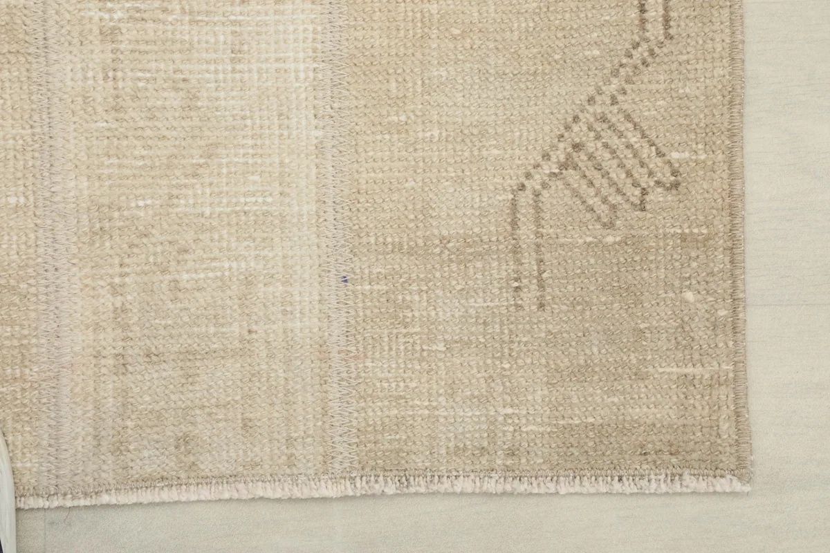 Corner detail of the rug, showing the finish of the edge and subtle fringe