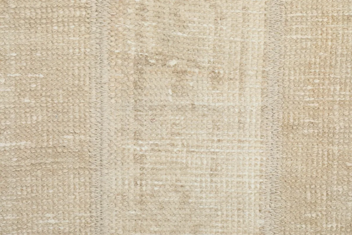 Close-up view of the low wool pile and the hand-knotted texture of the rug