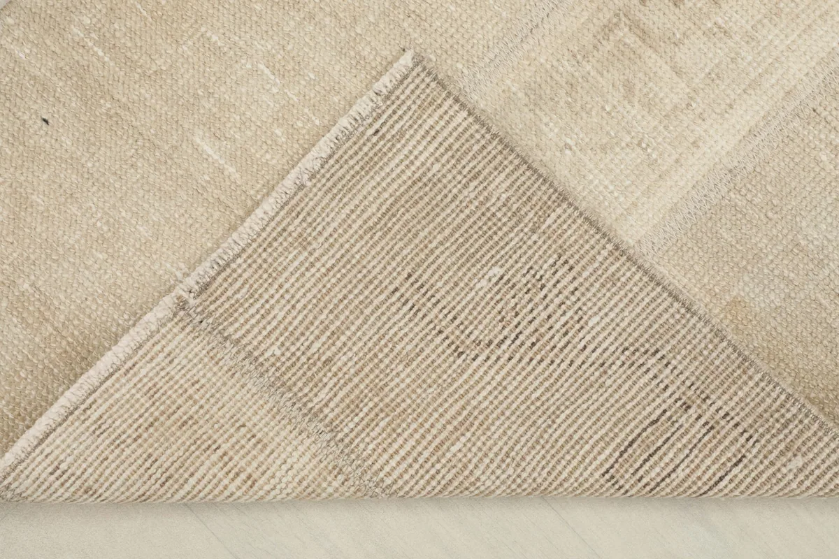 Underside view of the rug, revealing the cotton foundation and hand-knotted construction