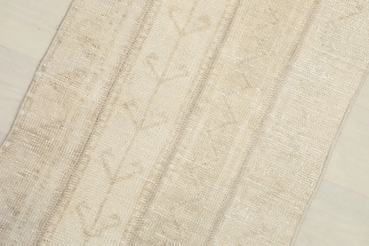 Close-up detail of the rug's surface, highlighting the subtle vertical geometric patterns.