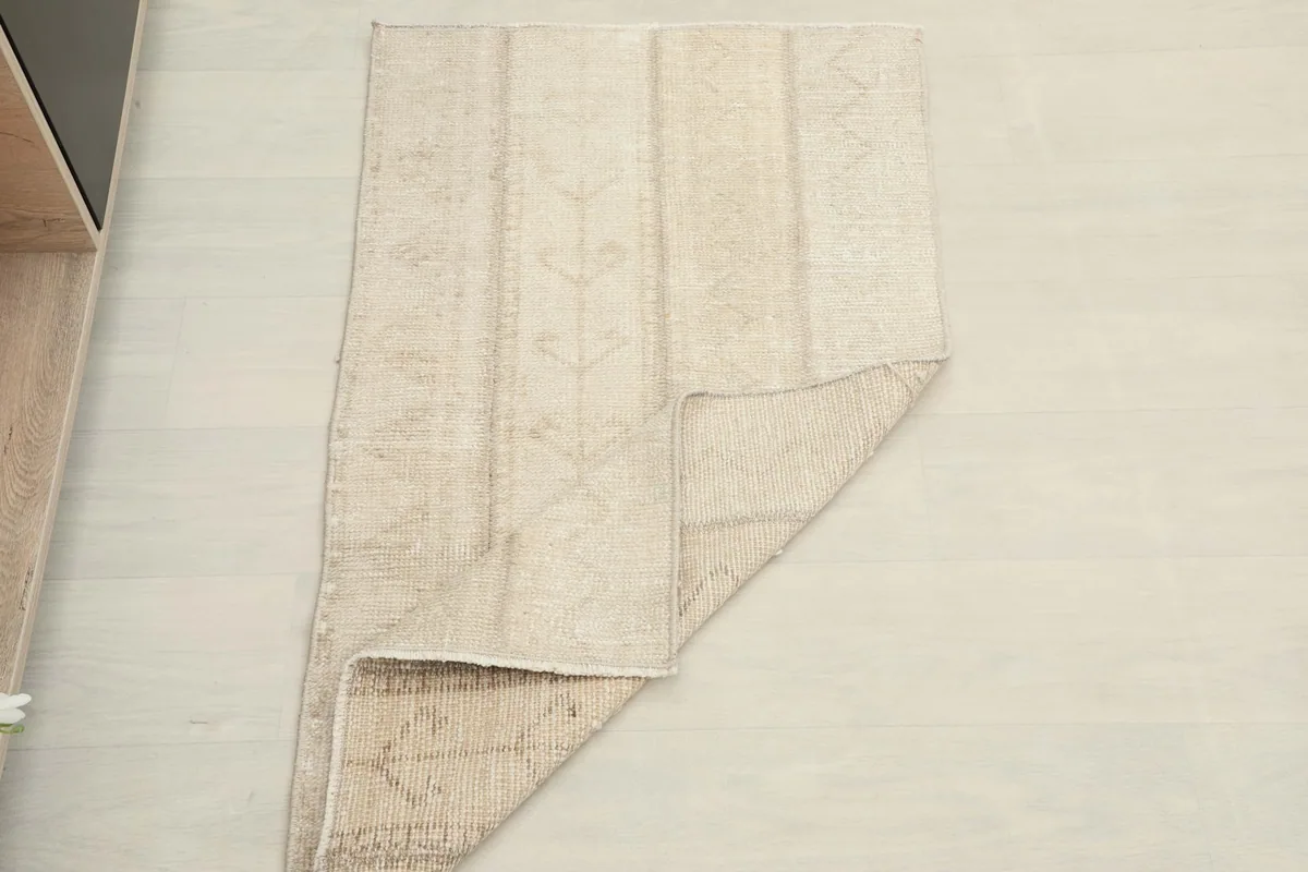 The rug partially folded to show the flexibility and thickness of the material.
