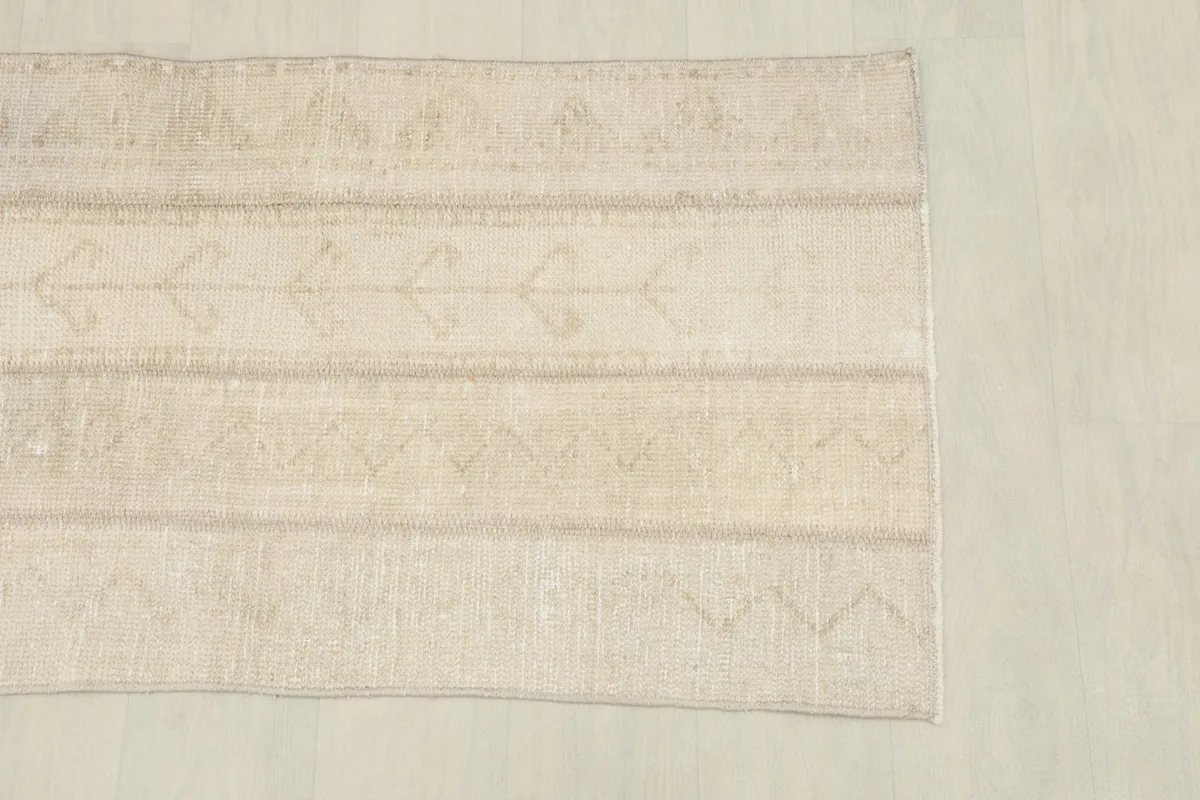 Overhead shot of one half of the rug, showing the horizontal bands of tribal motifs.