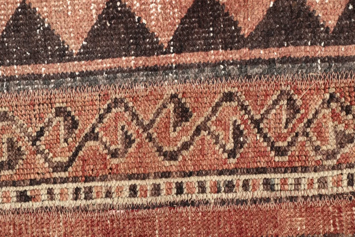Macro detail of a specific pattern band, showing the intricate hand-knotting and color variations