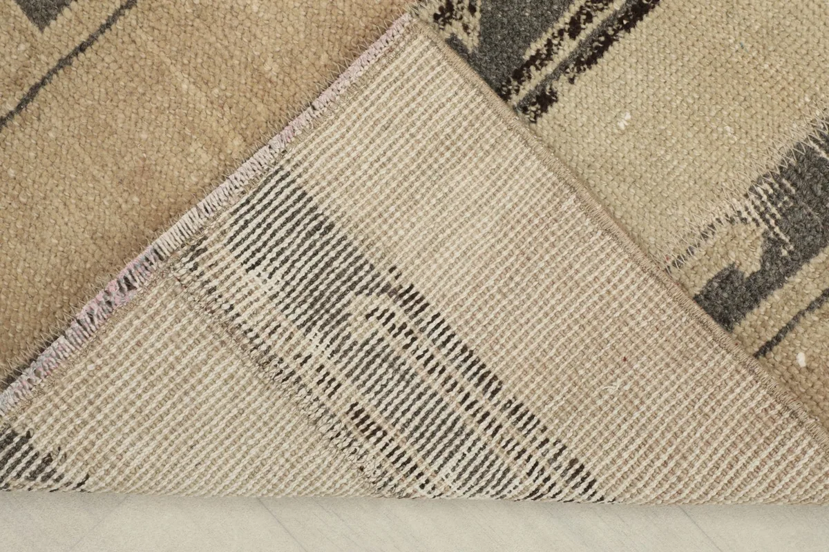 View of the back of the hand-knotted rug, revealing the cotton foundation and knotting.