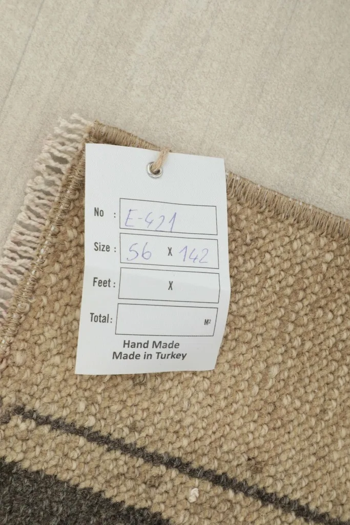 Image showing the product tag with rug dimensions and 'Hand Made Made in Turkey' label.