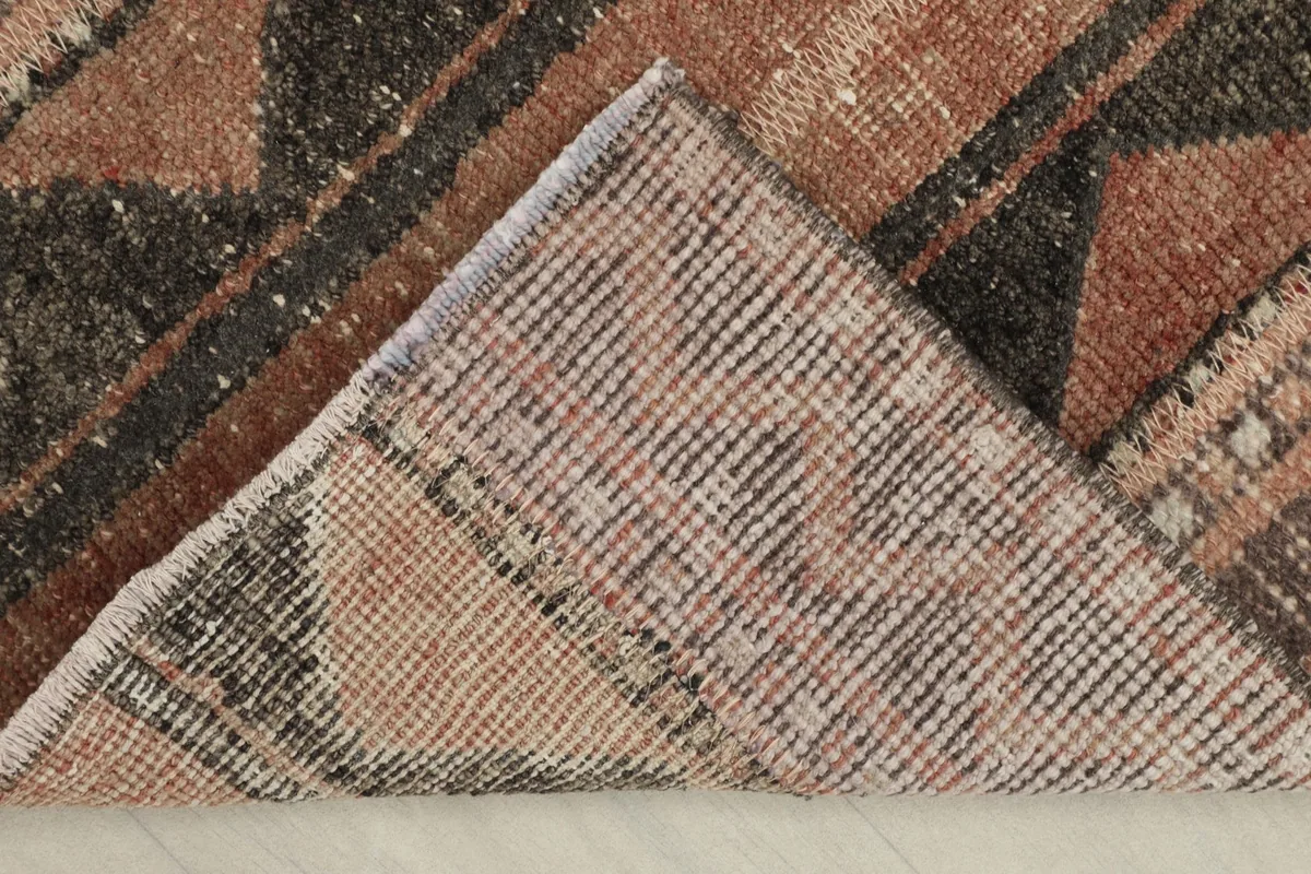 View of the back of the rug, revealing the cotton foundation and hand-knotted construction.