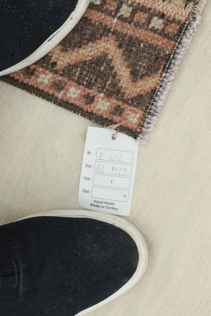 Size tag with feet for scale, confirming the 2'0" x 3'11" dimensions of the Anatolian rug.