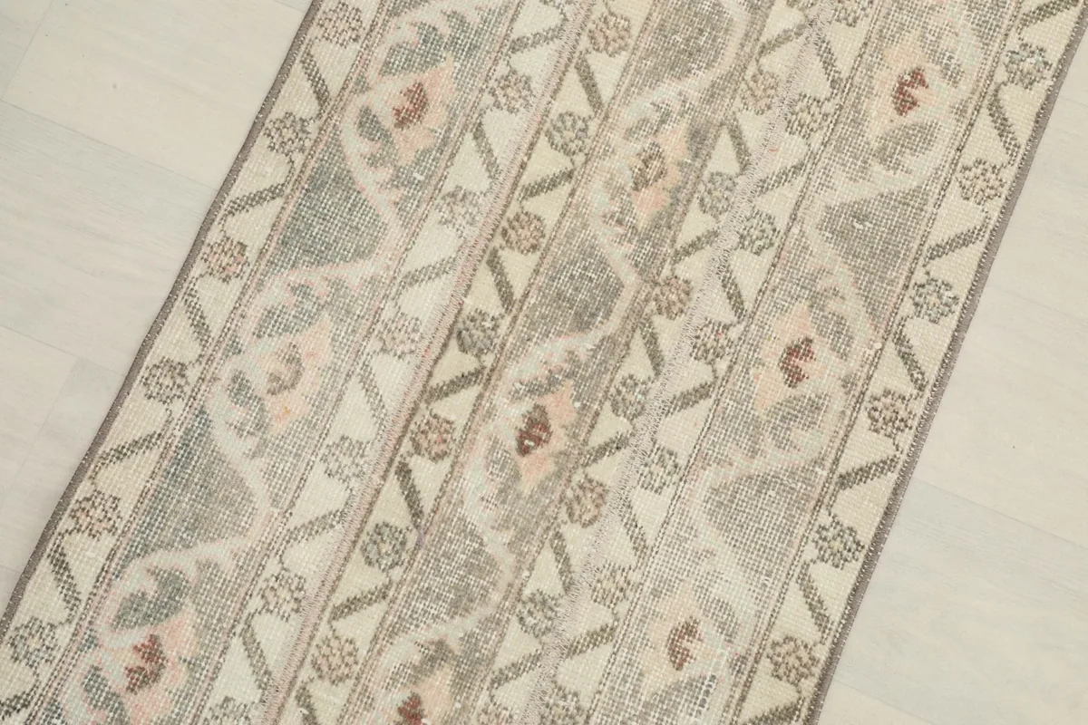 Close-up view of the central beige and gray patterns with pink and rust accents