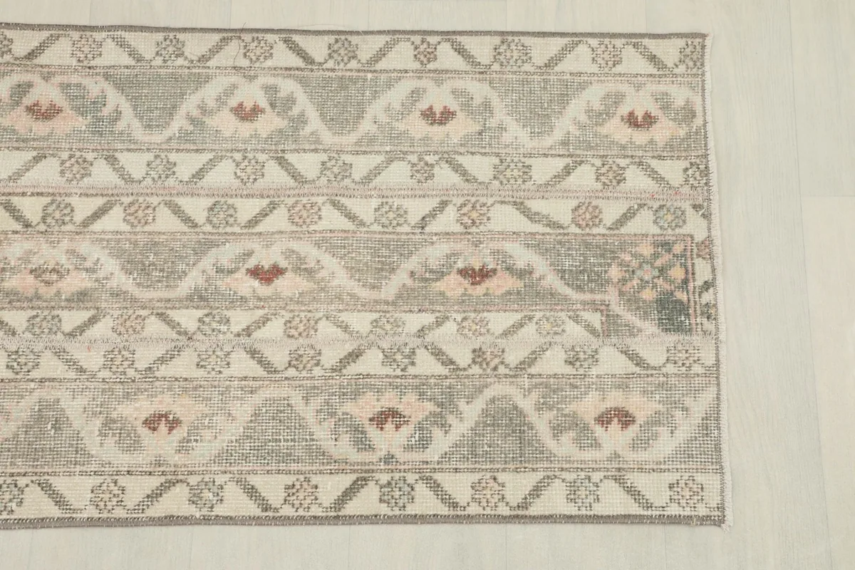 Detail of one end of the rug, showing the border design and faded colors