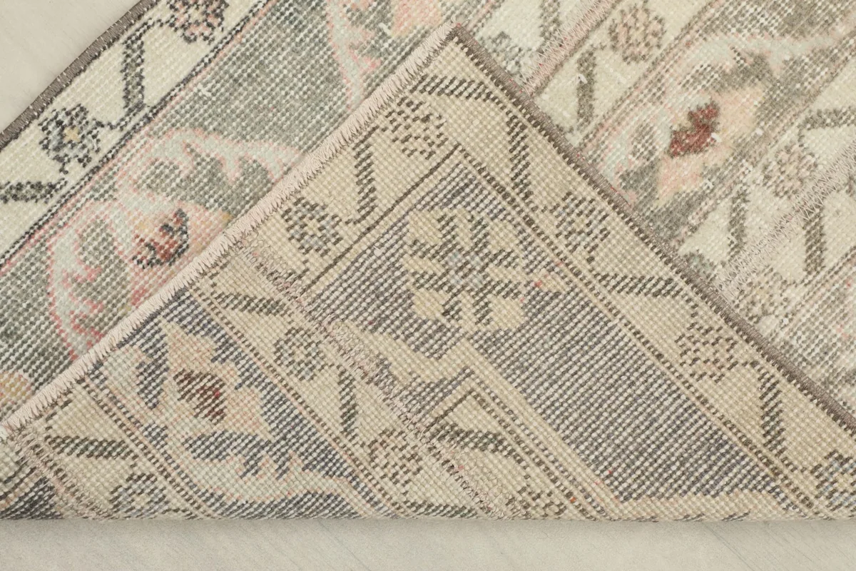 Underside of the rug, showing the cotton foundation and reverse of the knots