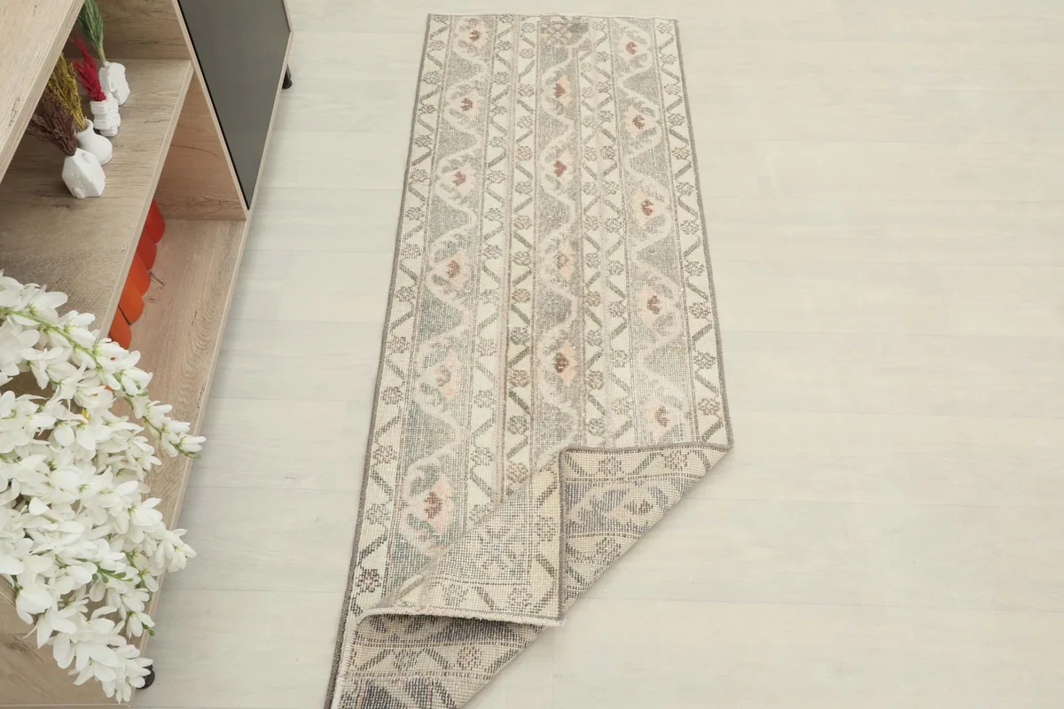 Overhead view of the runner rug partially folded, displaying the full design