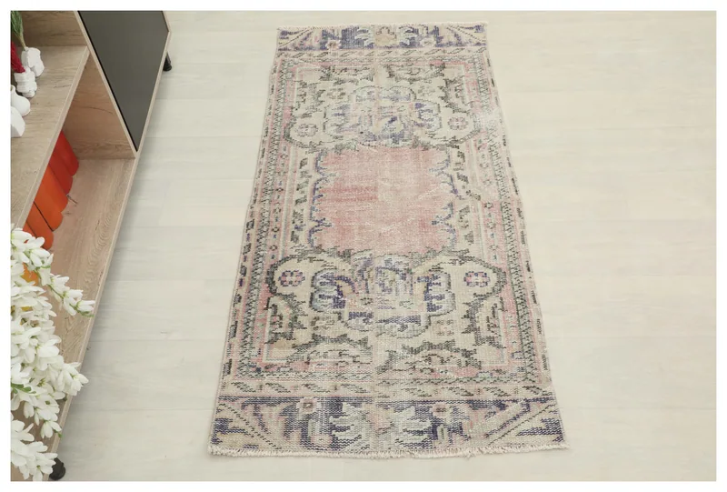 Full top view of the 2x5 vintage rose Anatolian rug on a white background