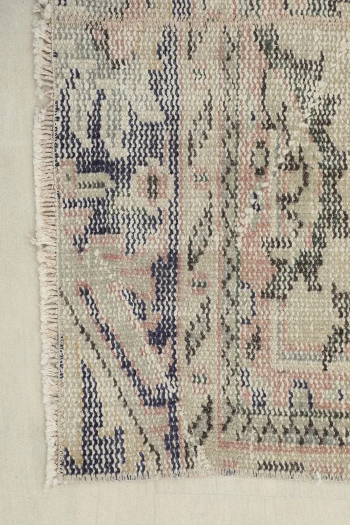 Detail of the rug's border and fringe, showing the edge craftsmanship