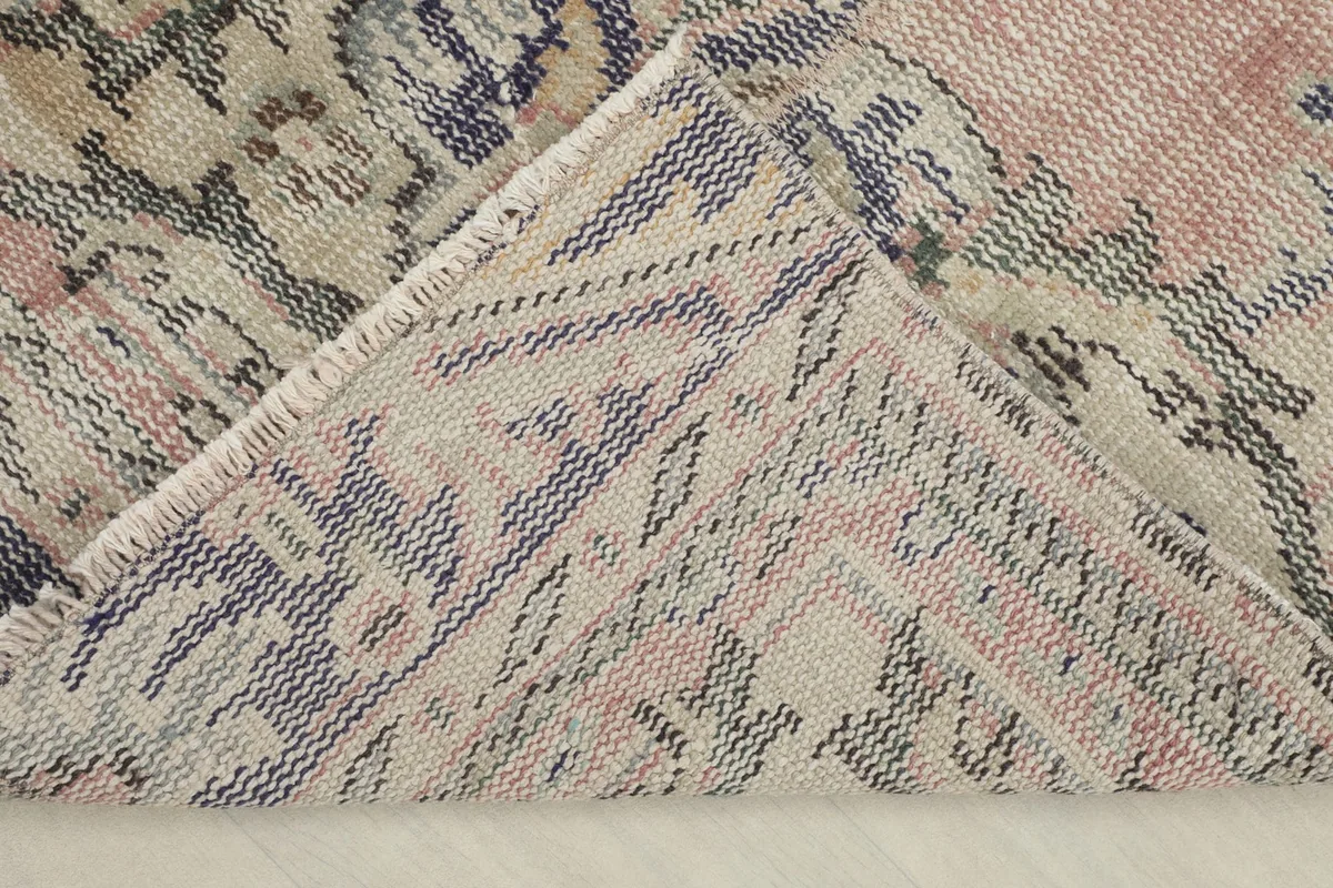 View of the rug's underside, revealing the hand-knotted cotton foundation