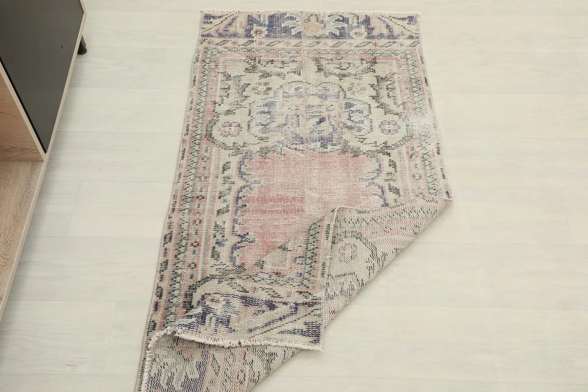View of the rug partially folded, showing its flexibility and full pattern