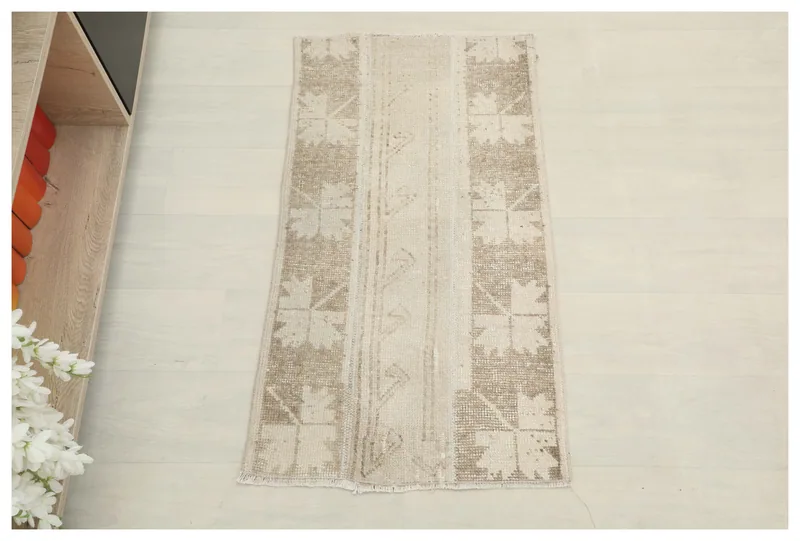 Full top view of the beige and tan geometric vintage Anatolian rug on a white background