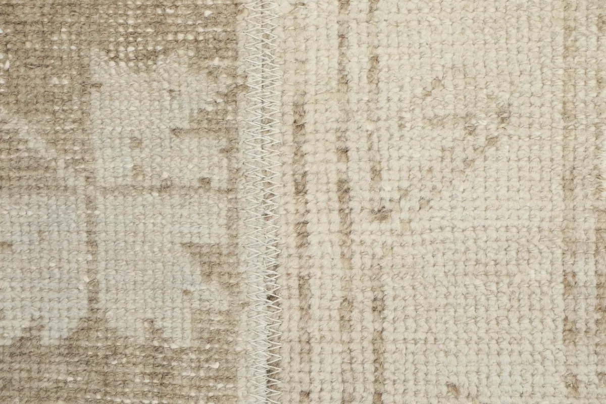 Close-up detail of the low wool pile and hand-knotted texture of the rug