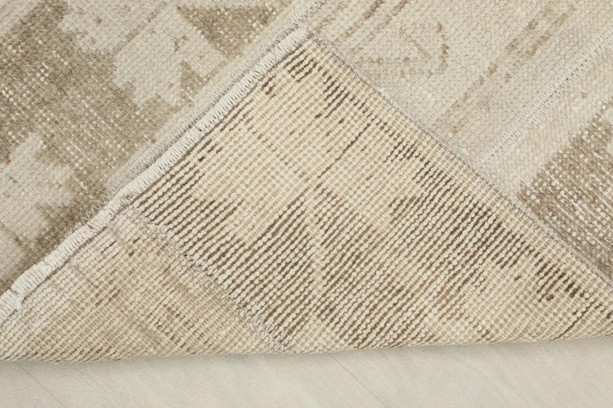 View of the back of the rug, showing the cotton foundation and knotting