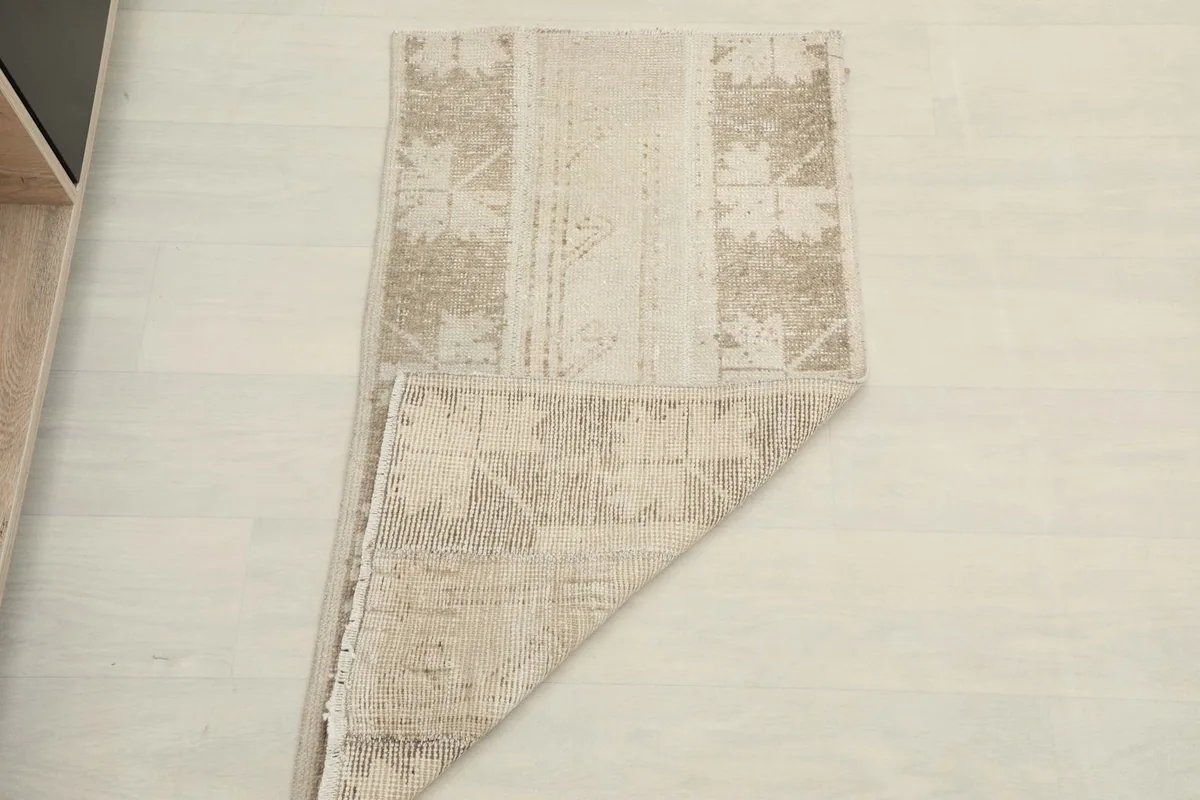 Rug partially folded, demonstrating its flexibility and thickness