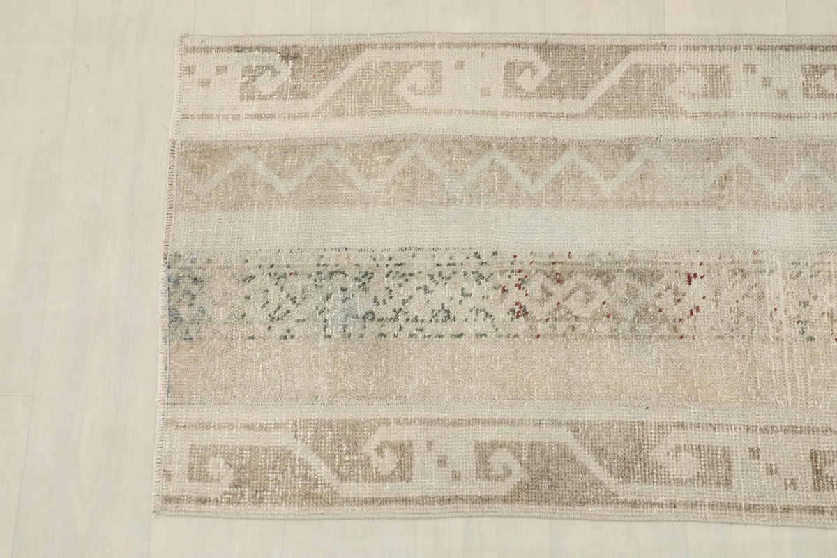 Overhead close-up of the other end of the rug, detailing the tribal patterns and striped bands.