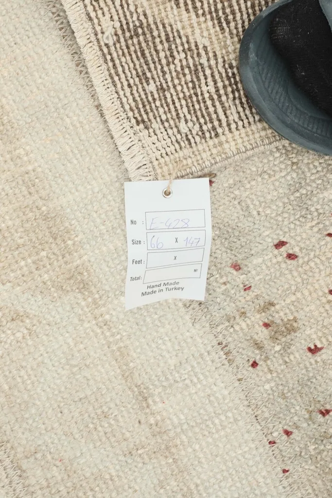 Close-up of the care tag, confirming the hand-knotted origin and material details of the rug.