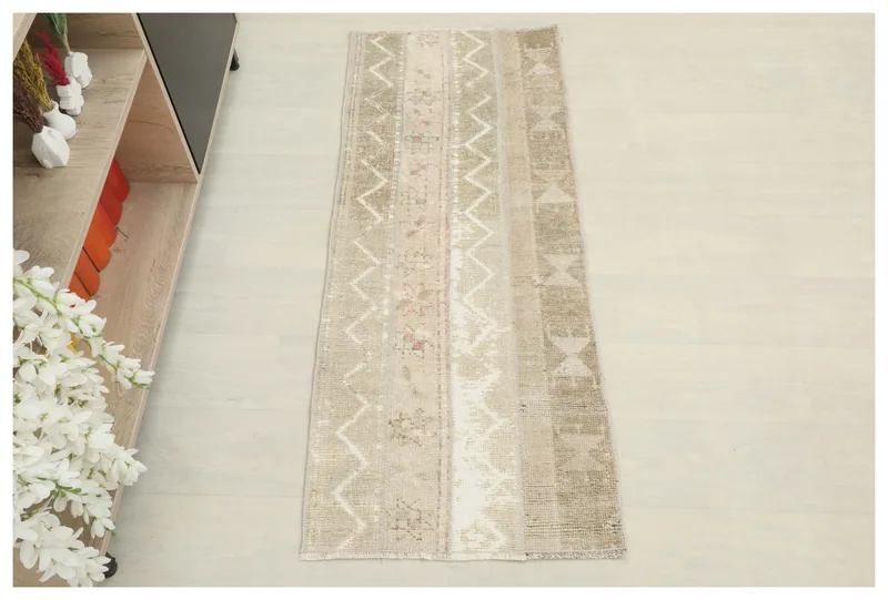 Full top view of the 1'10" x 4'7" beige tribal geometric runner on a white background