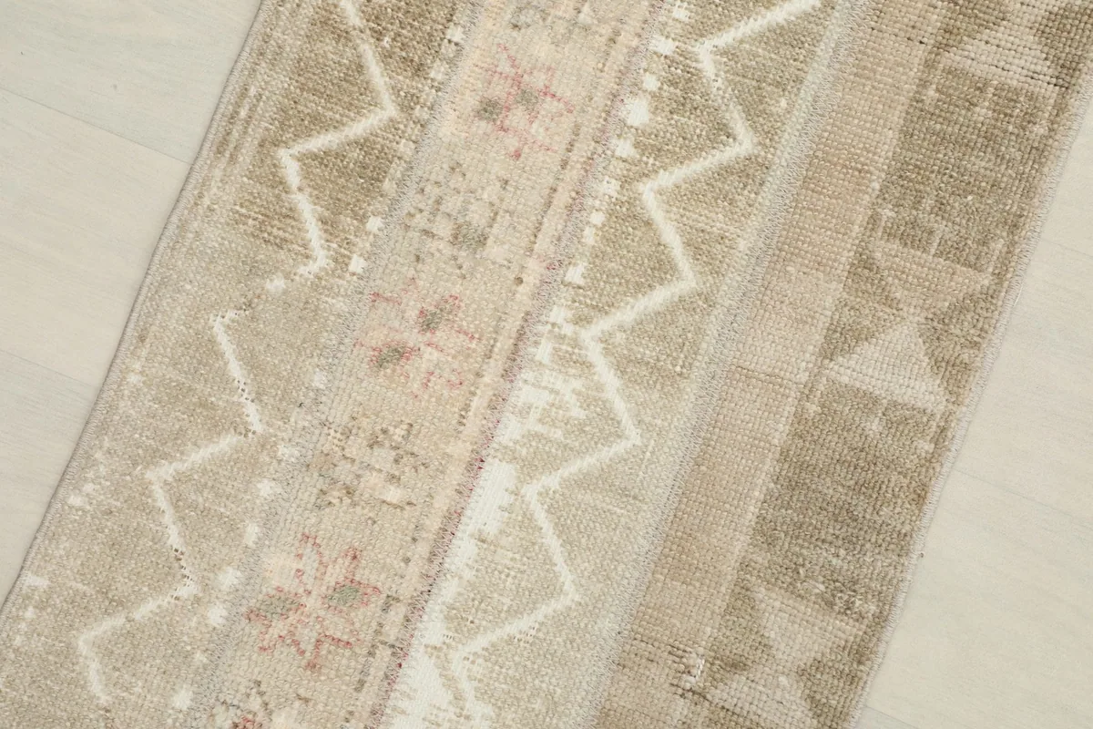 Close-up detail of the varied beige and cream tones with distinct geometric shapes