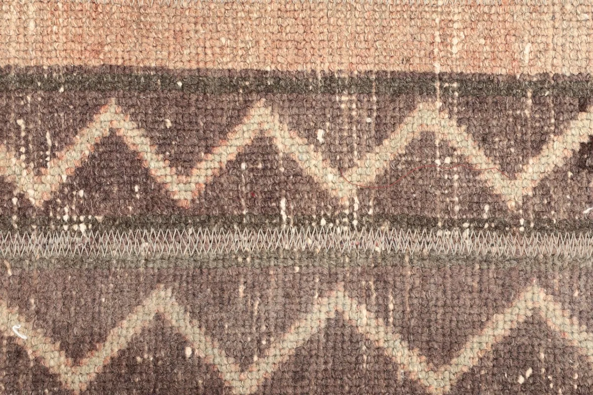 Close-up of the textured surface, highlighting a light beige zigzag design on a brown field