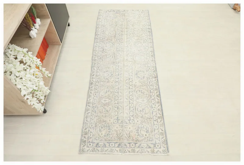 Full top view of the 2'6" x 6'6" ivory and blue vintage Anatolian runner rug on a white background.